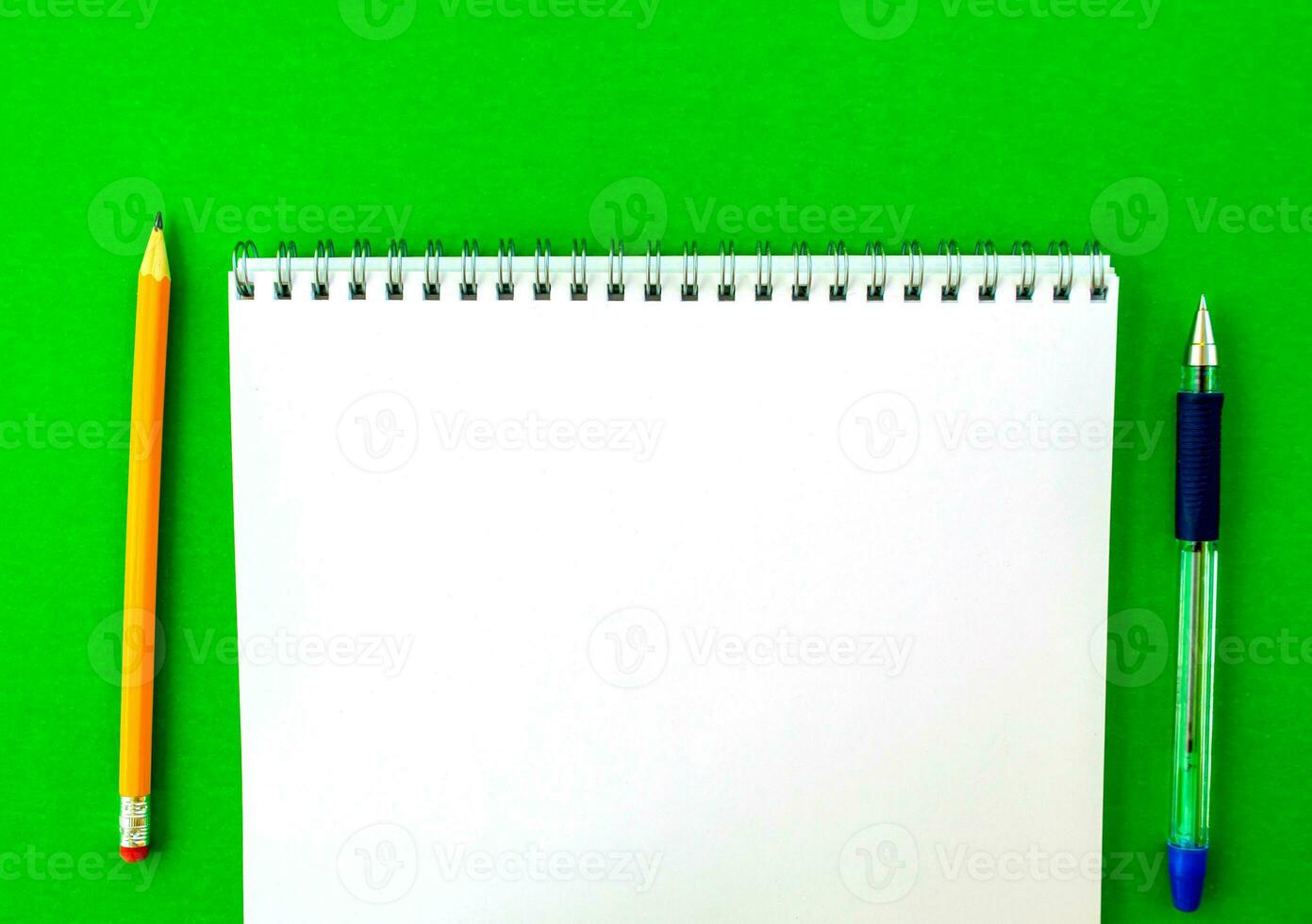 White notepad with spring, pen and pencil. photo