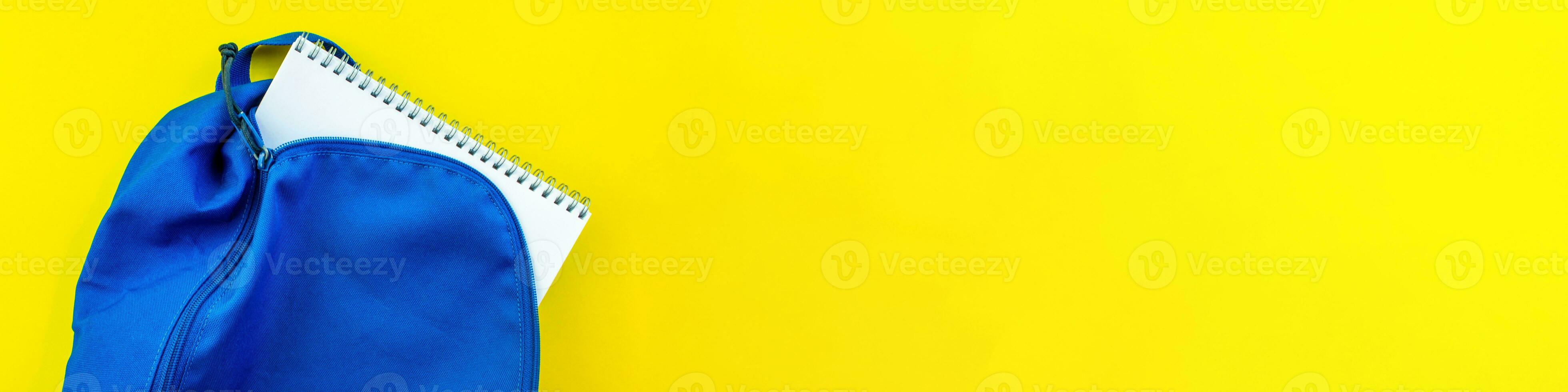 Banner.School backpack and notebook on a yellow background. photo