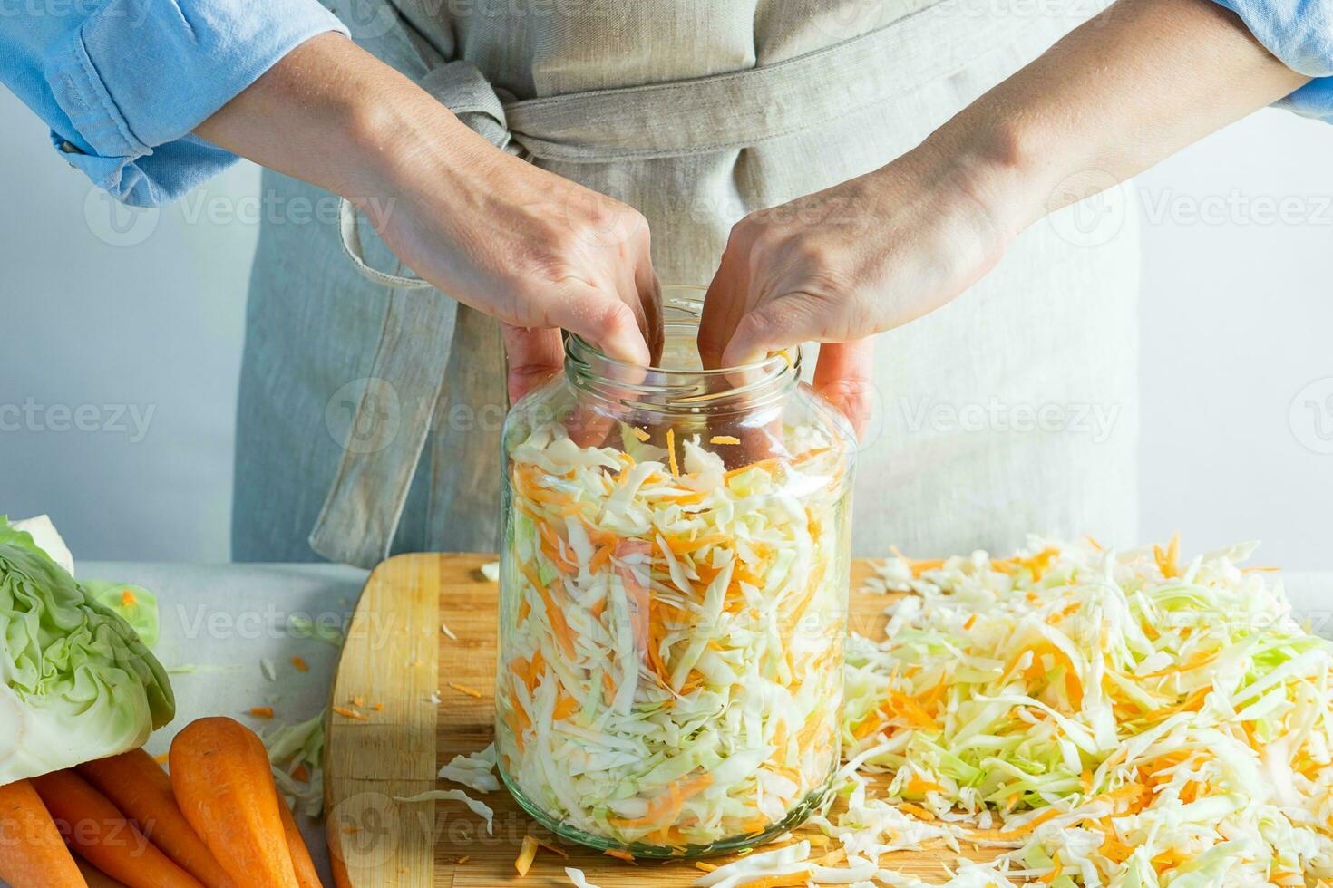The preparation process fermentation preservation Sauerkraut on a light background. Natural rustic style. Canned food photo