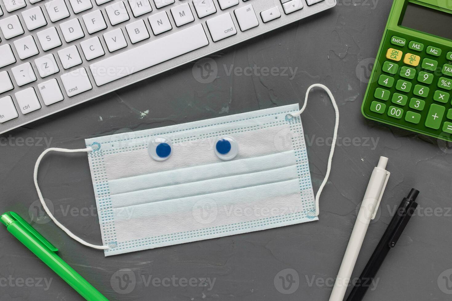 Mask, notebook and calculator. Tax return concept photo