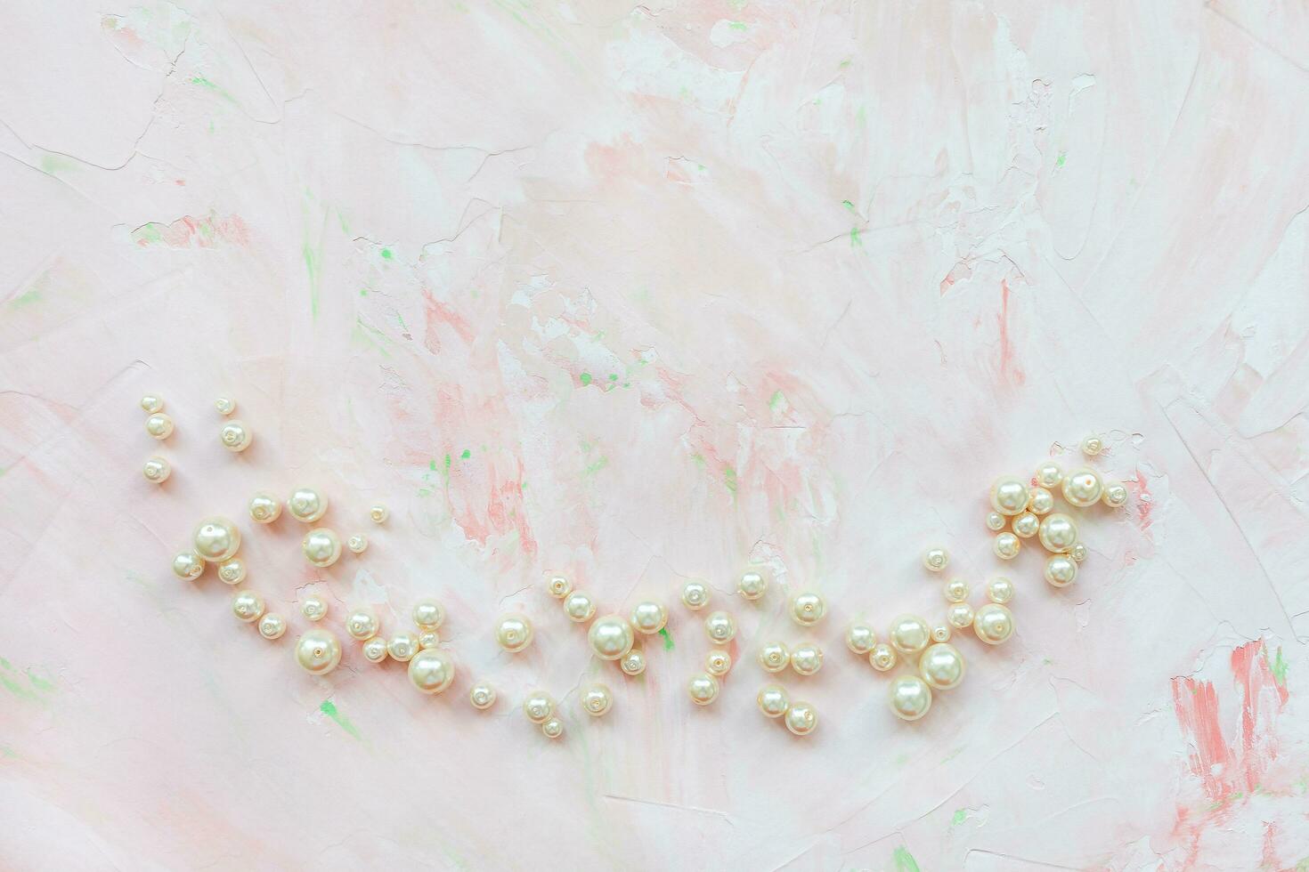 White pearls on pink. Creative abstract background photo