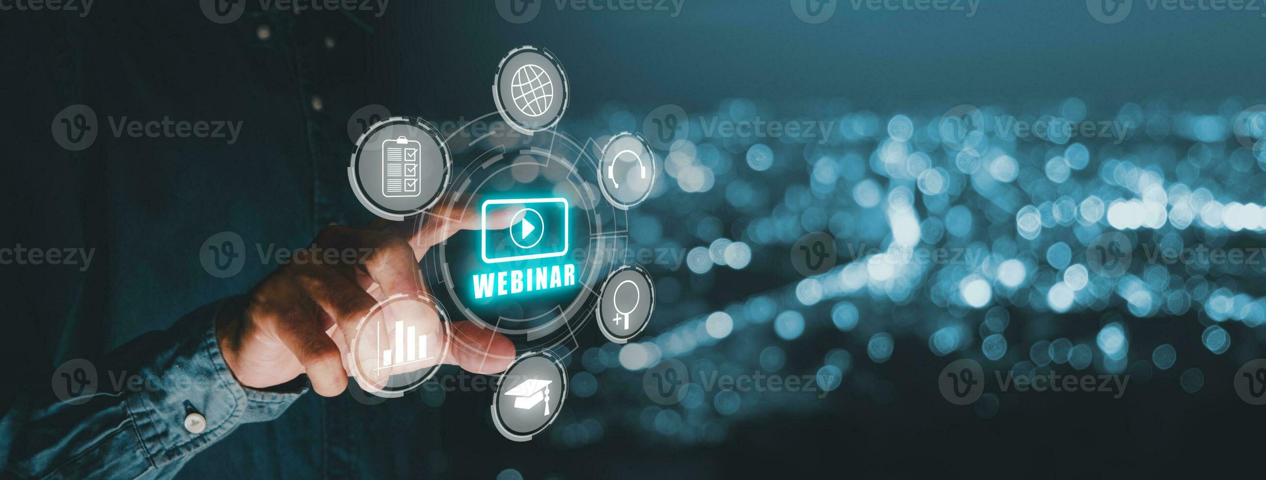 Webinar e-learning training business internet technology concept. Person hand toucing VR screen webinar icon on blue bokeh background. photo