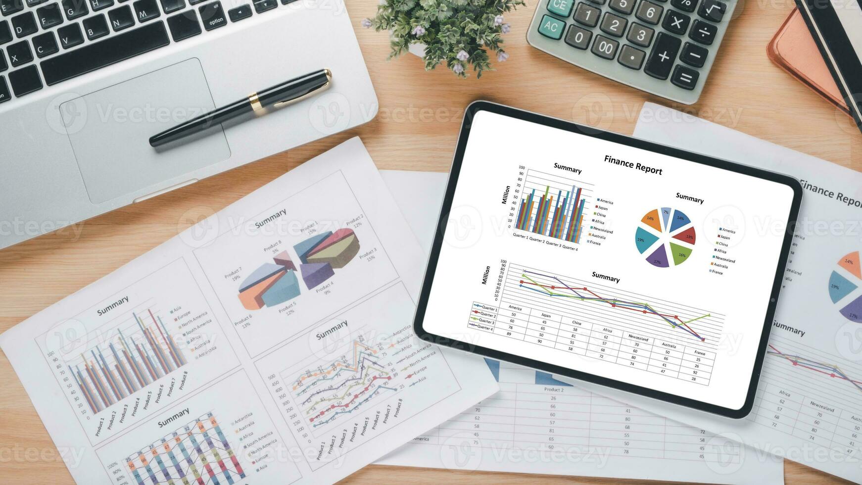 Tablet with charts and reports on office desk workplace. Top view flat lay photo