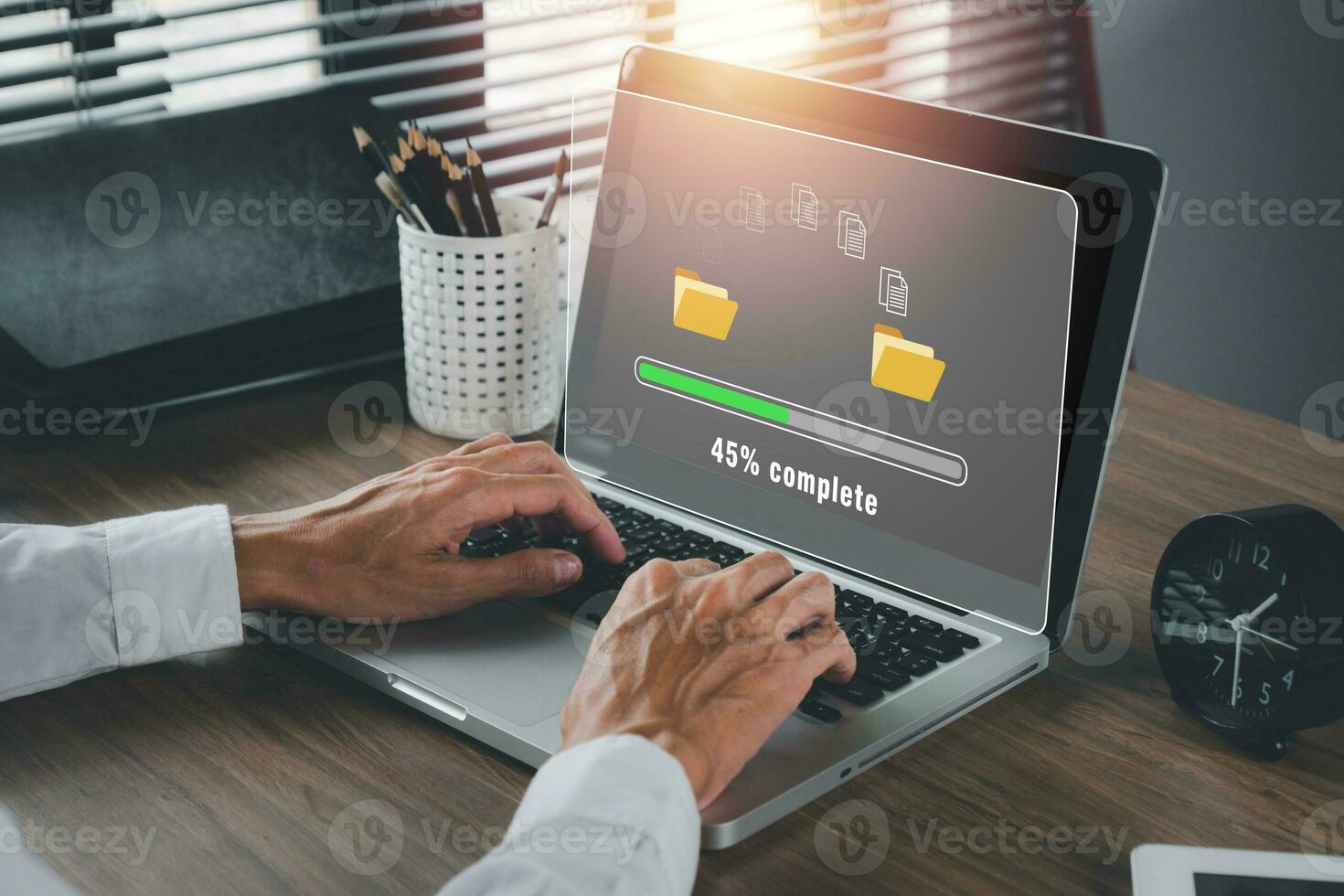 ransfer files data system relocation concept, Person hand using laptop computer waiting for transfer file process with loading bar icon on virtual screen. photo