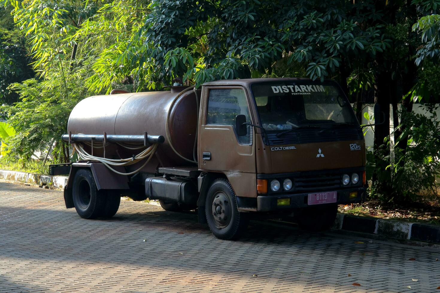 Purwakarta, 05 May 2023 - The DISTARKIM Watering Car is parked next to the mosque garden, located in Cilodong, Purwakarta photo