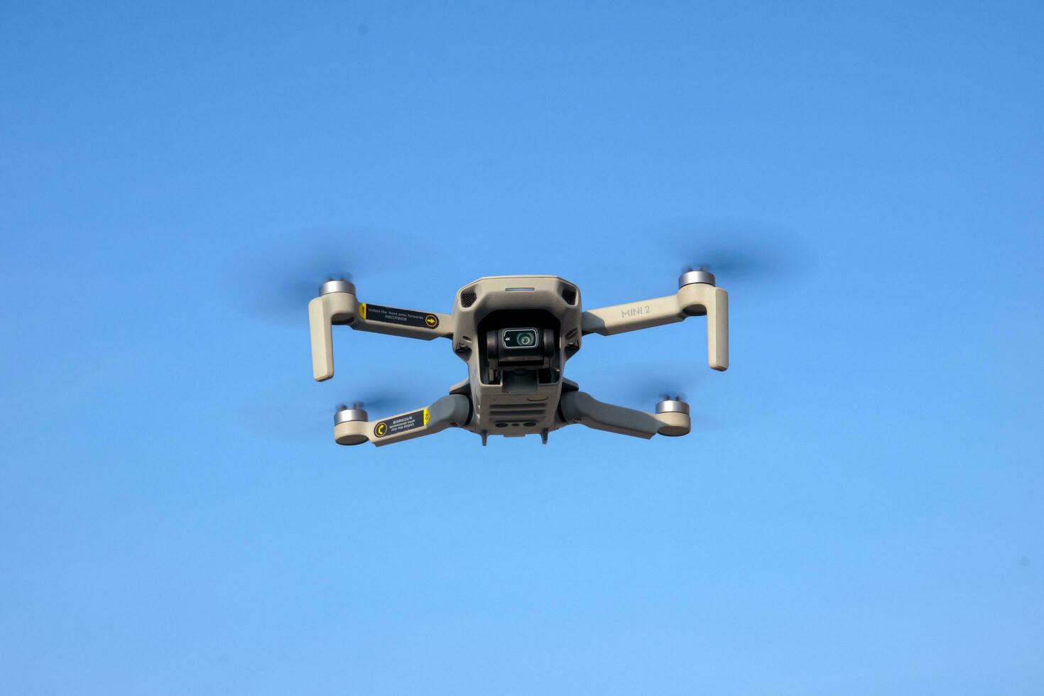 Purwakarta, 05 May 2023 - DJi Mavic mini drone flying against a blue sky background, located in Cilodong, Purwakarta photo