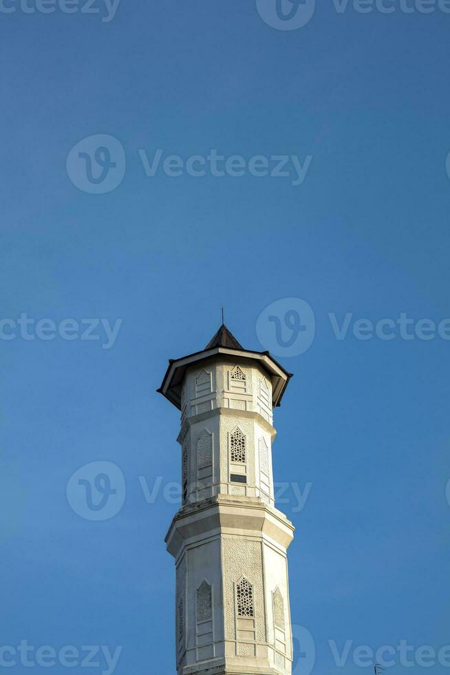 Purwakarta, 05 May 2023 - View of the minaret of the Tajug Gede Cilodong Mosque against a blue sky as a background, located in Cilodong, Purwakarta photo