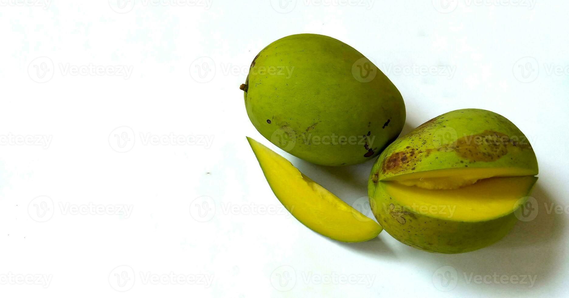 Slice of fresh mango with green skin color isolated on white background. photo