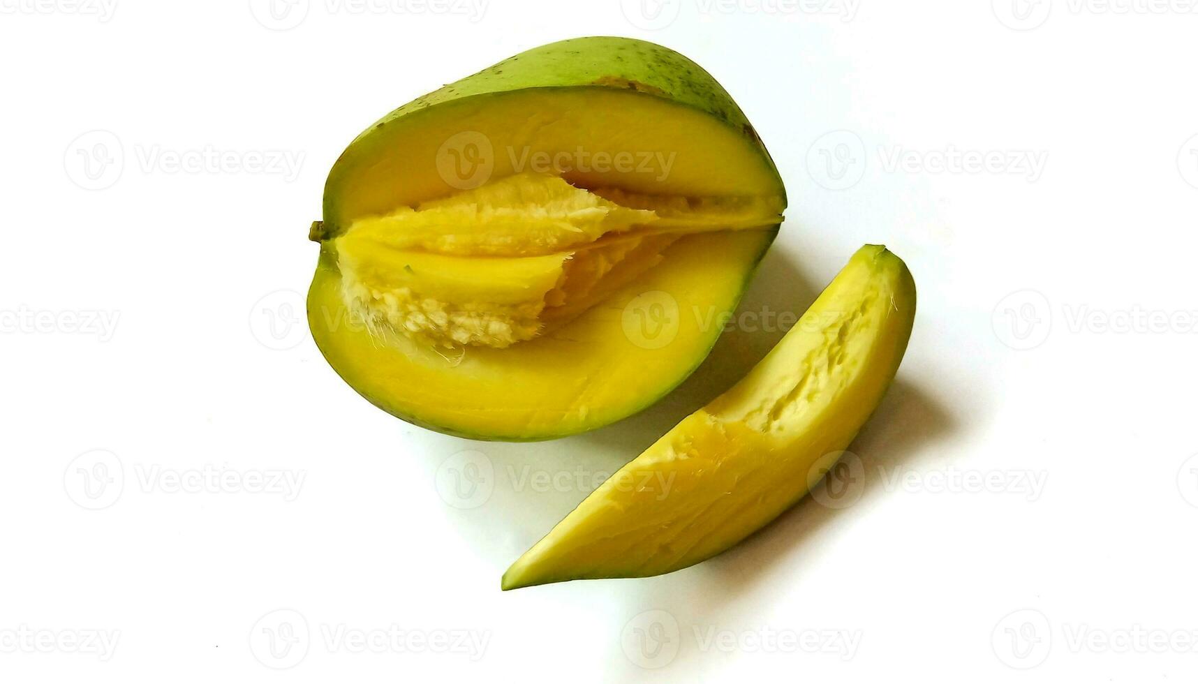 Slice of fresh mango with green skin color isolated on white background. photo