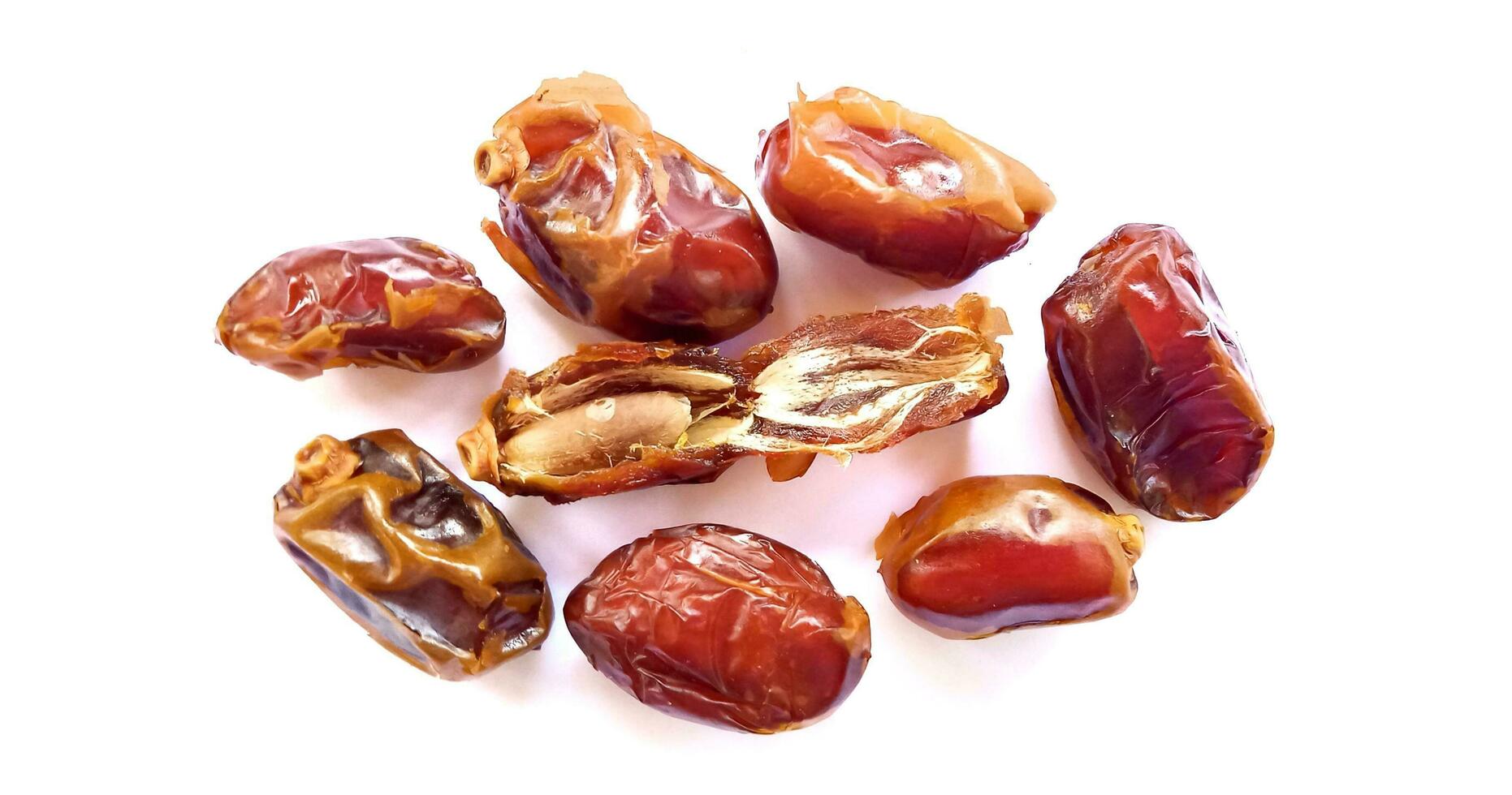 Pile of tasty dry dates isolated on white background. Kurma, buah kurma