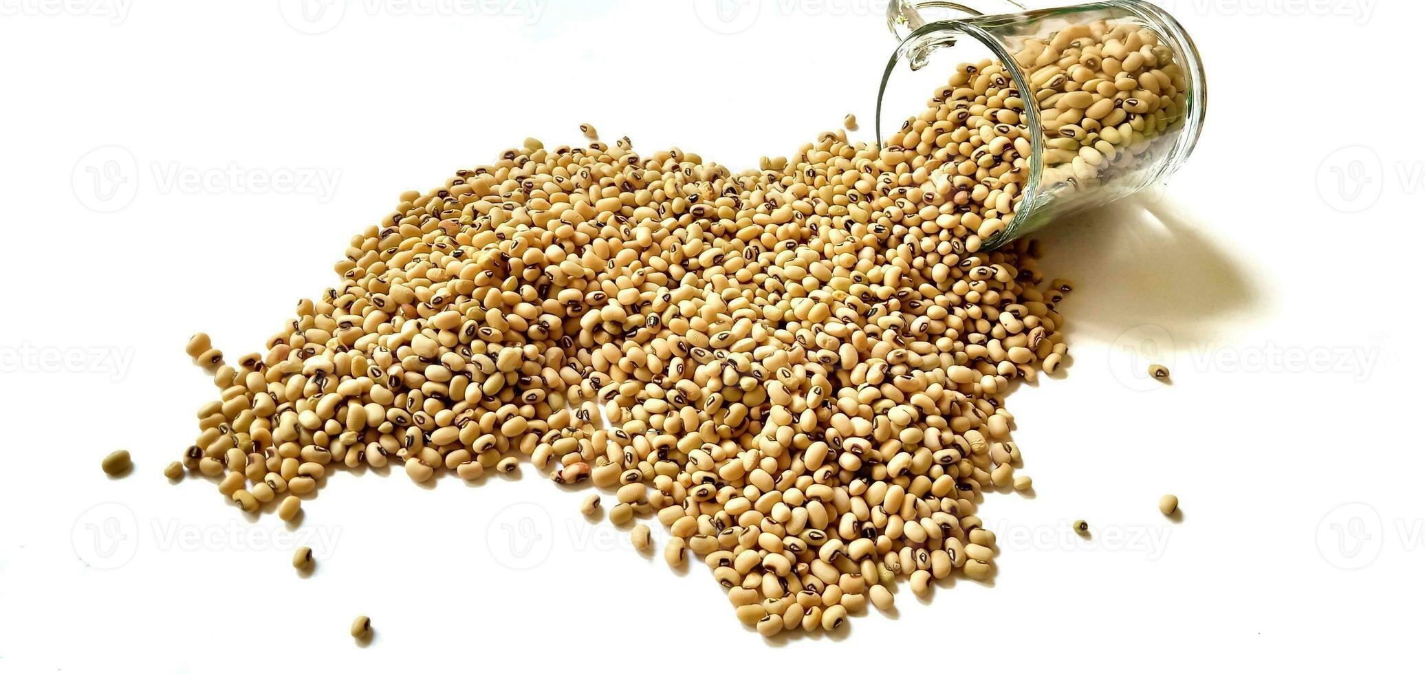 Black Eyed Peas or beans spilled from glasses over on white background. photo