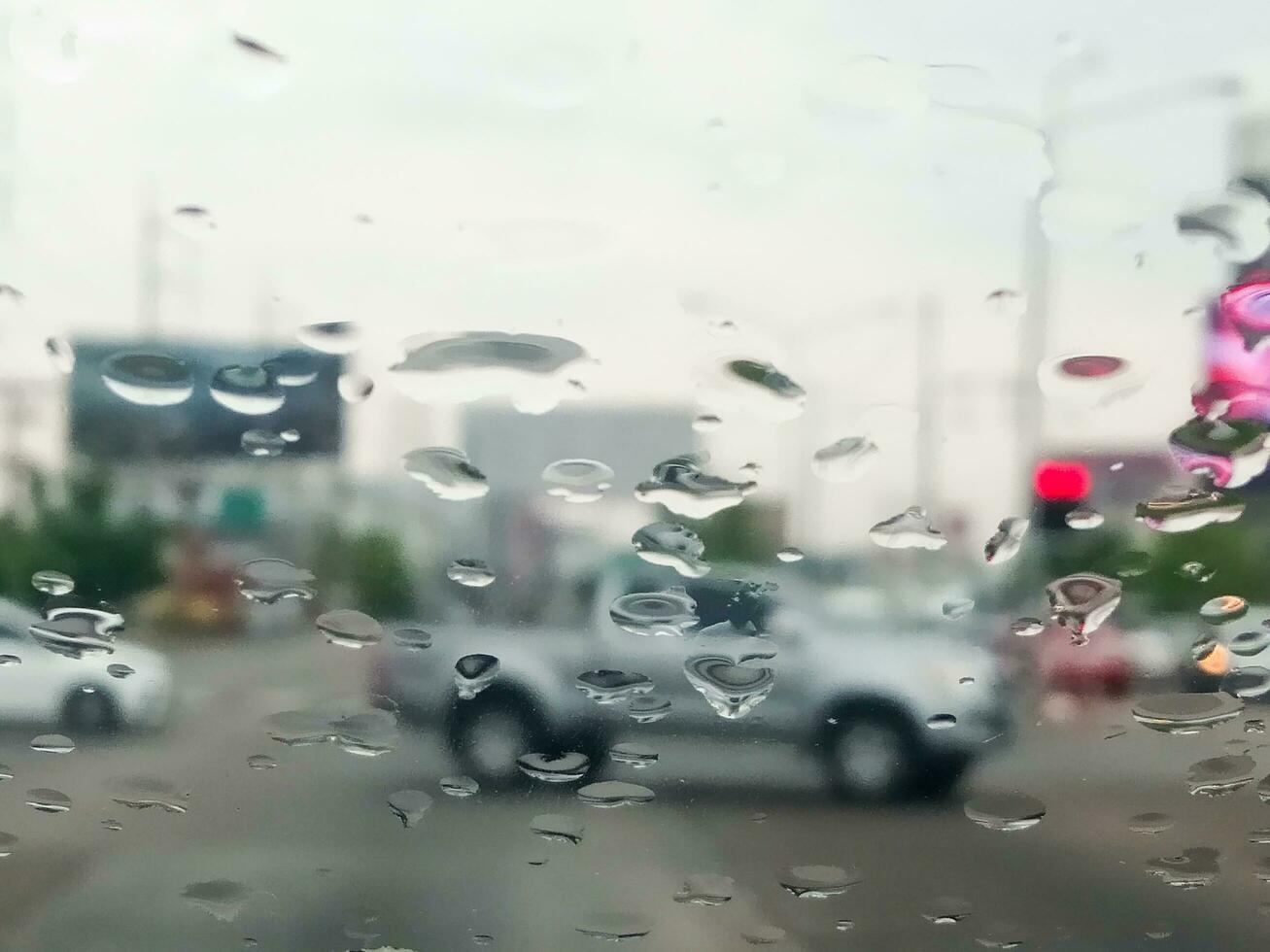 rain drops on the windshield  traffic on a rainy day photo