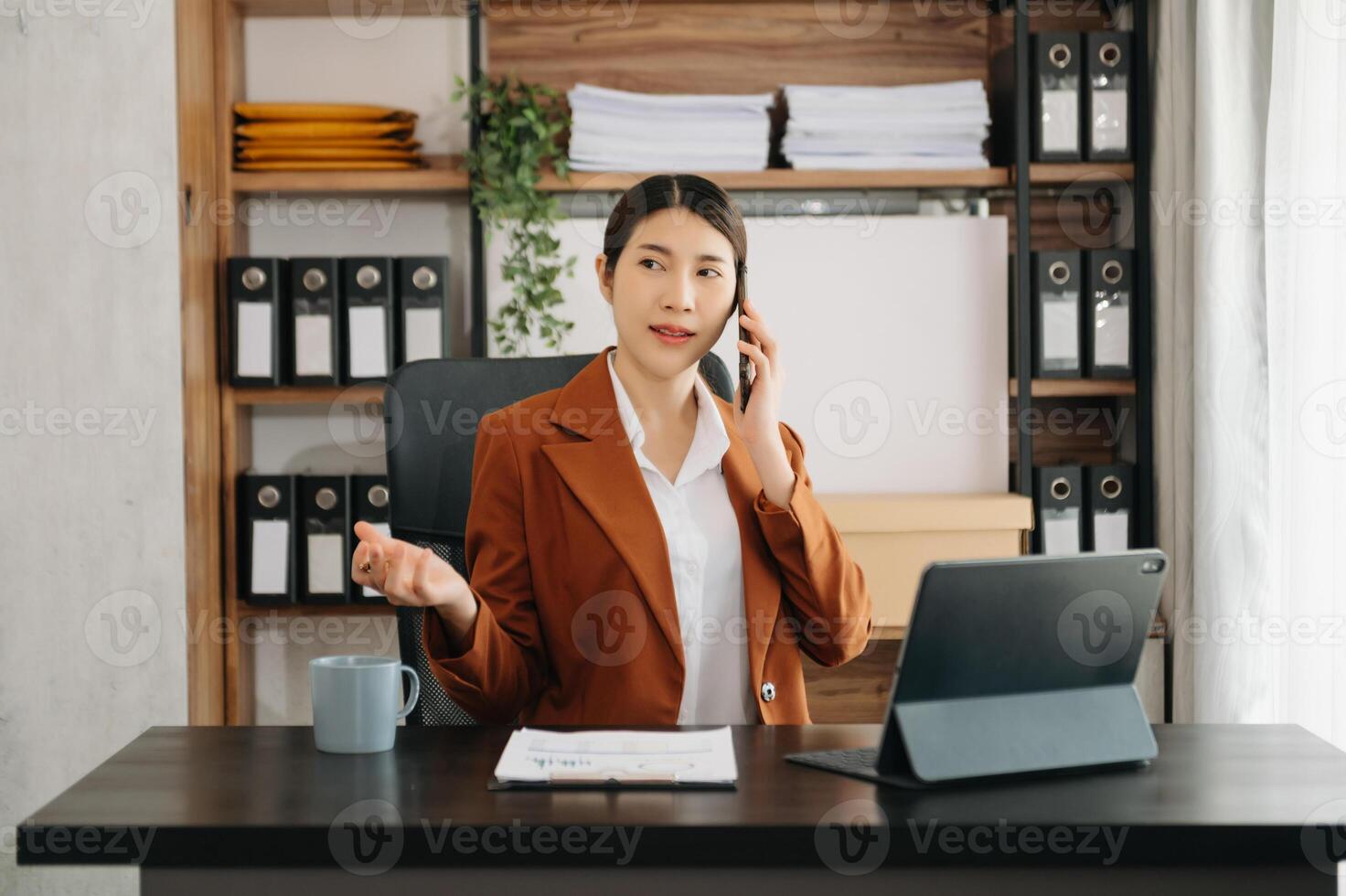 Business woman using tablet and laptop for doing math finance on an office desk, tax, report, accounting, statistics, and analytical research concept in office photo