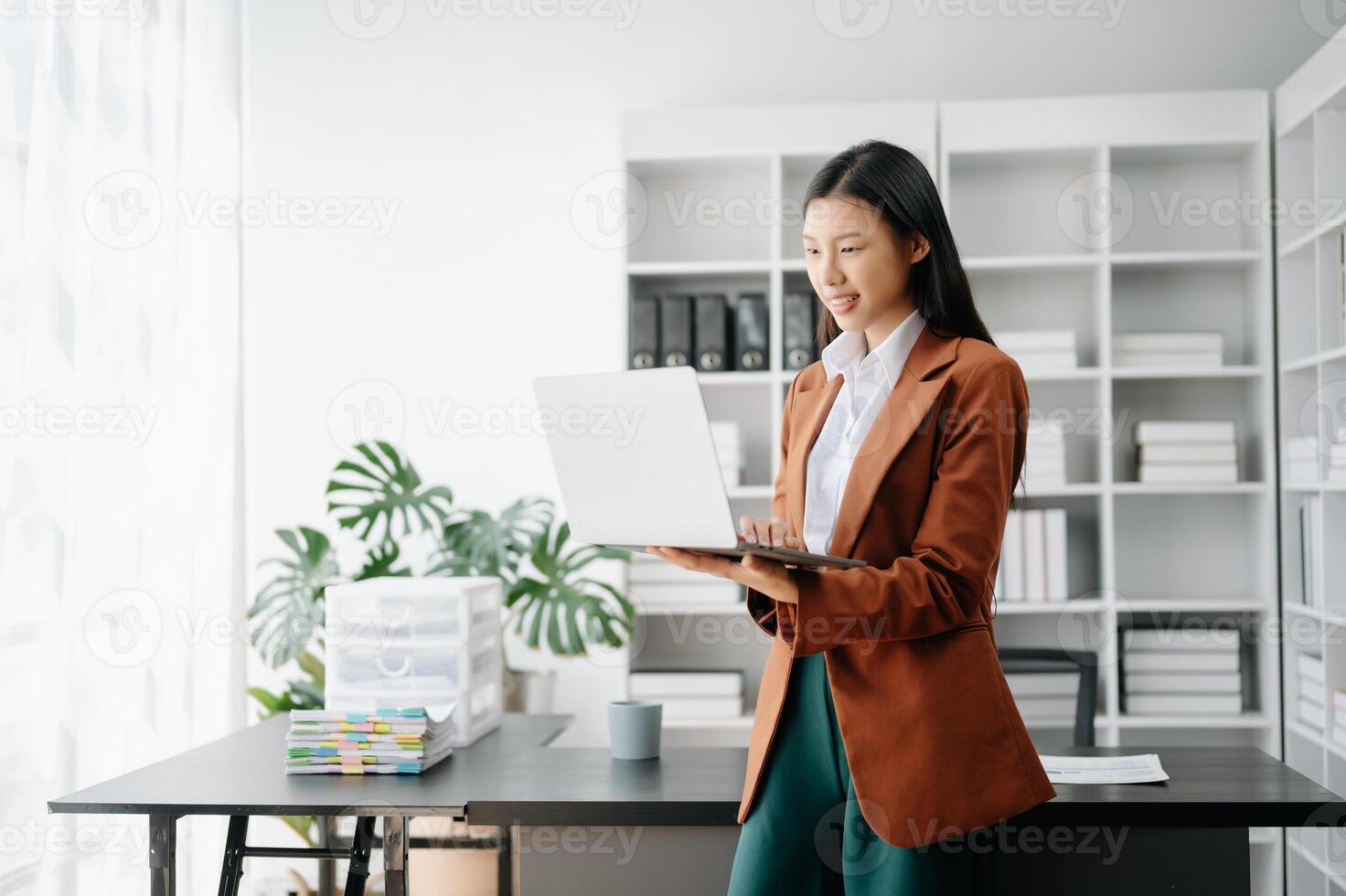 Business woman using tablet and laptop for doing math finance on an office desk, tax, report, accounting, statistics, and analytical research concept in office photo