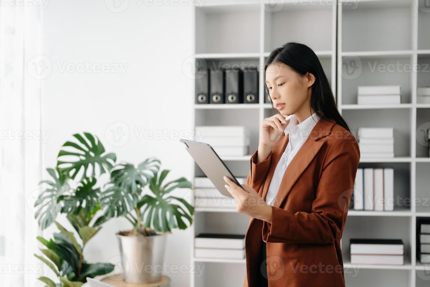 Business woman using tablet and laptop for doing math finance on an office desk, tax, report, accounting, statistics, and analytical research concept in office photo