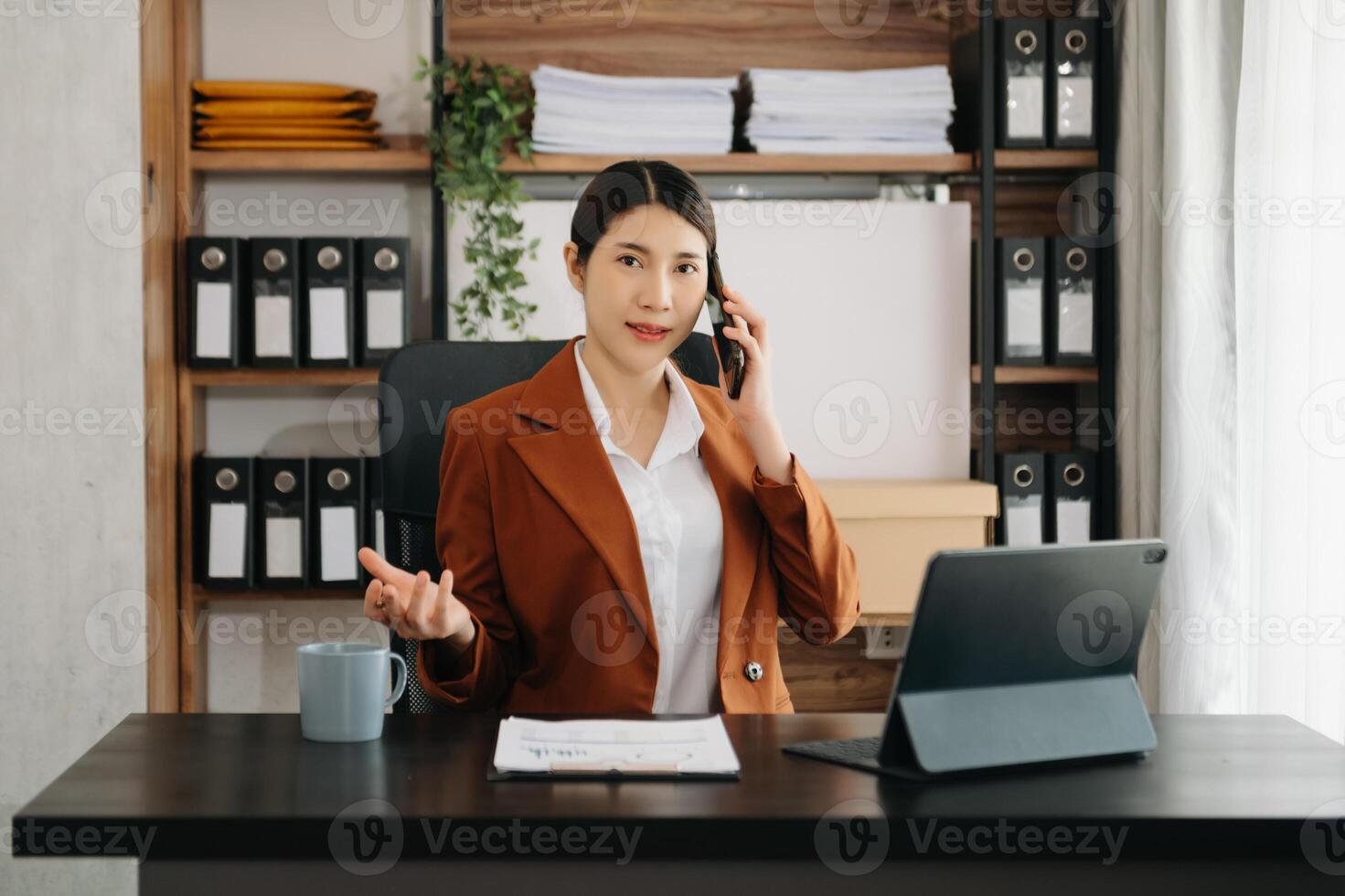 Business woman using tablet and laptop for doing math finance on an office desk, tax, report, accounting, statistics, and analytical research concept in office photo