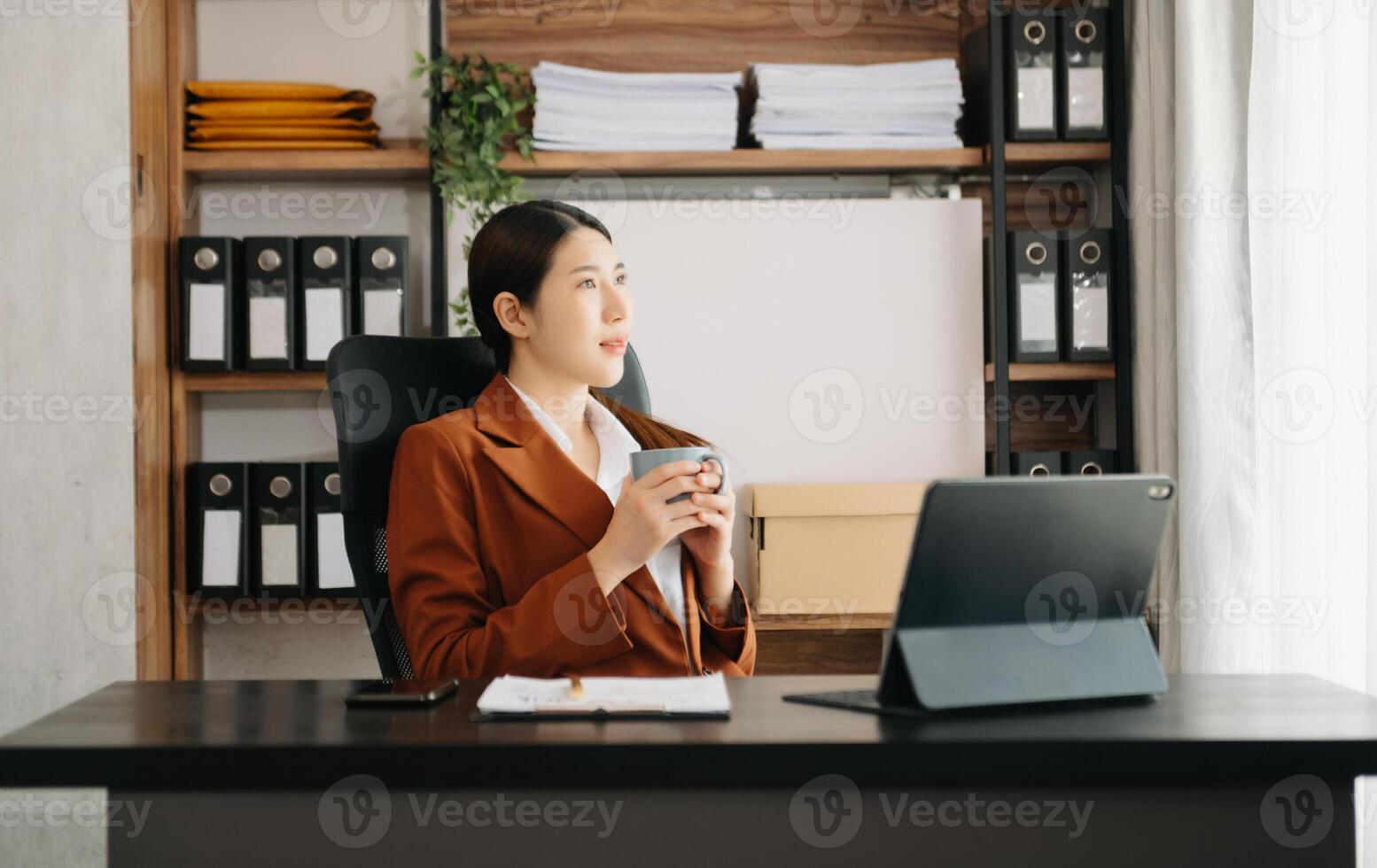 Business woman using tablet and laptop for doing math finance on an office desk, tax, report, accounting, statistics, and analytical research concept in office photo