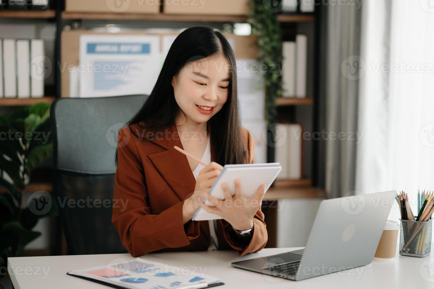 Business woman using tablet and laptop for doing math finance on an office desk, tax, report, accounting, statistics, and analytical research concept photo