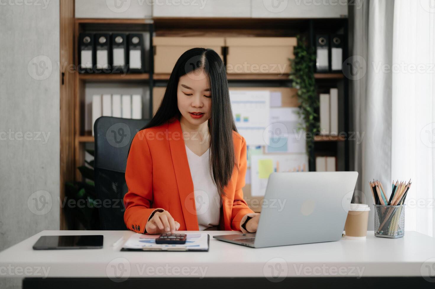 Business woman using tablet and laptop for doing math finance on an office desk, tax, report, accounting, statistics, and analytical research concept photo