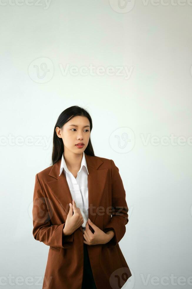 Portrait photo of young beautiful Asian woman feeling happy and holding smart phone, tablet and laptop with black empty screen on white background product presenting concept.