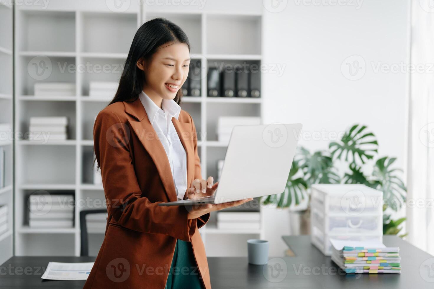 Business woman using tablet and laptop for doing math finance on an office desk, tax, report, accounting, statistics, and analytical research concept in office photo