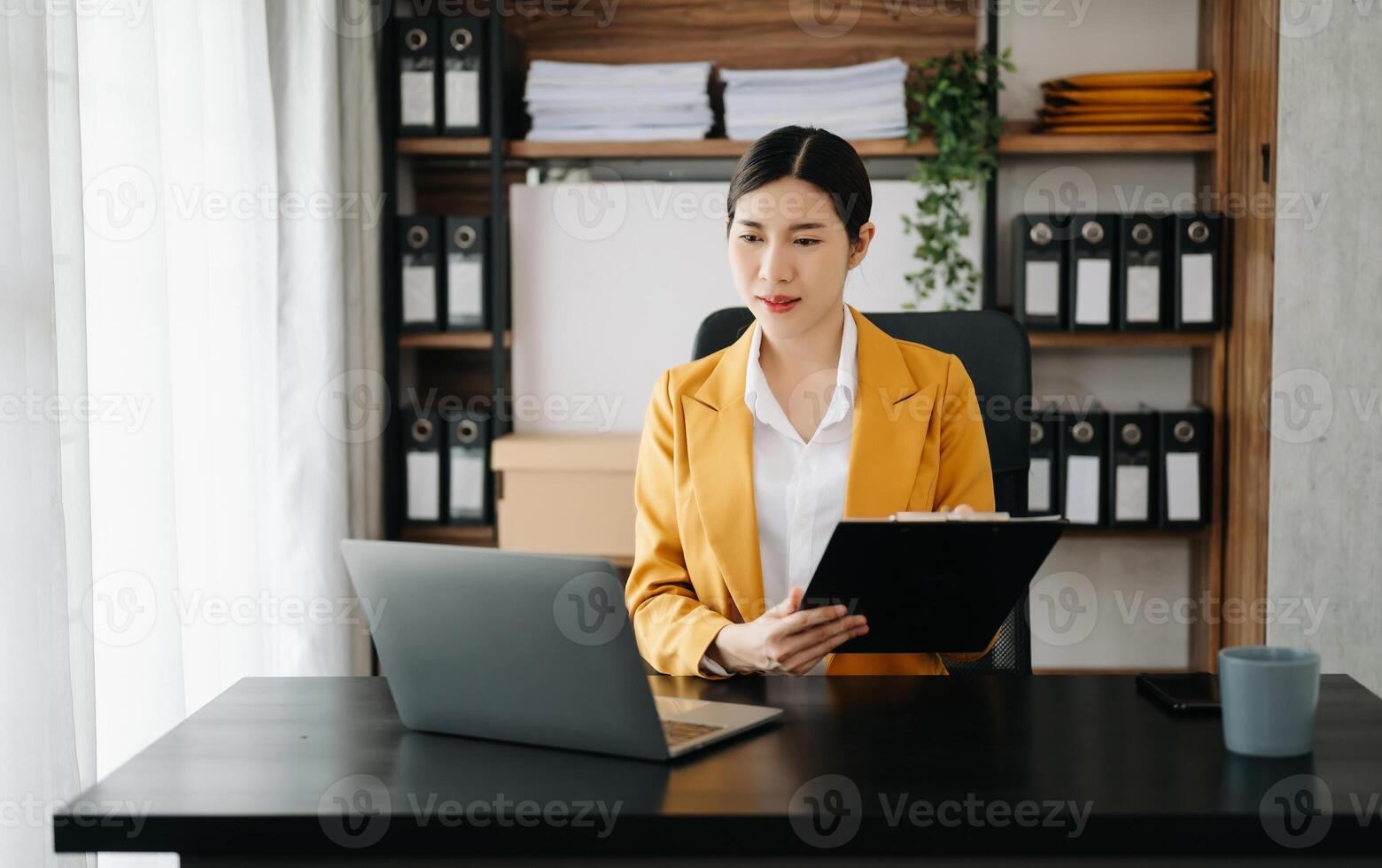 Business woman using tablet and laptop for doing math finance on an office desk, tax, report, accounting, statistics, and analytical research concept in office photo