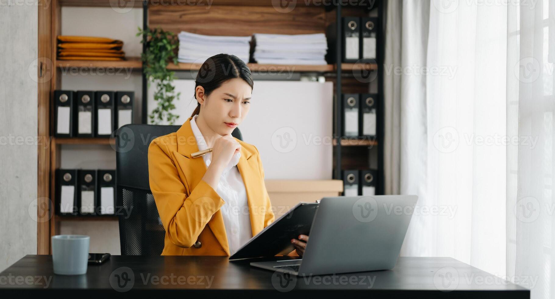 Business woman using tablet and laptop for doing math finance on an office desk, tax, report, accounting, statistics, and analytical research concept in office photo