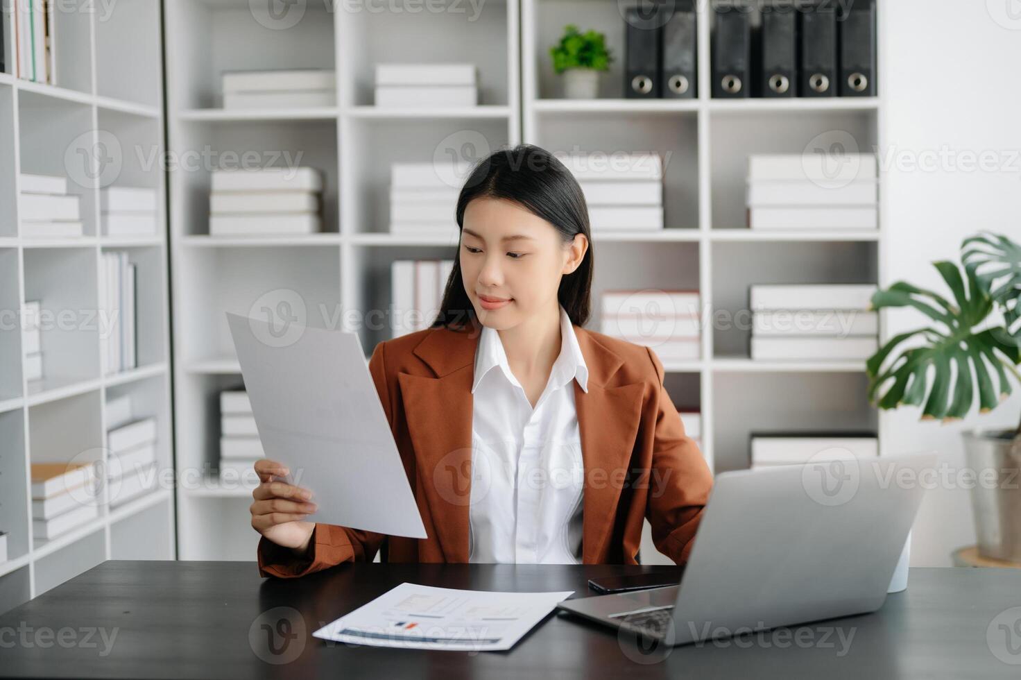 Business woman using tablet and laptop for doing math finance on an office desk, tax, report, accounting, statistics, and analytical research concept in office photo