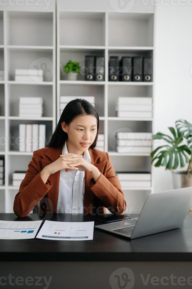 Business woman using tablet and laptop for doing math finance on an office desk, tax, report, accounting, statistics, and analytical research concept in office photo