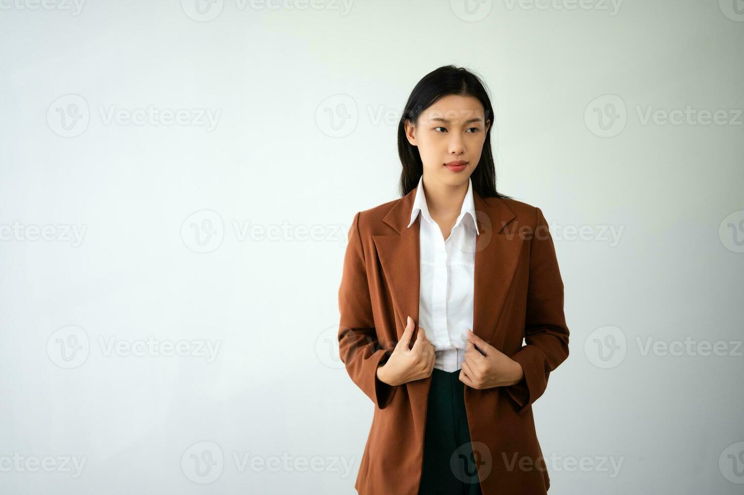 Portrait photo of young beautiful Asian woman feeling happy and holding smart phone, tablet and laptop with black empty screen on white background product presenting concept.