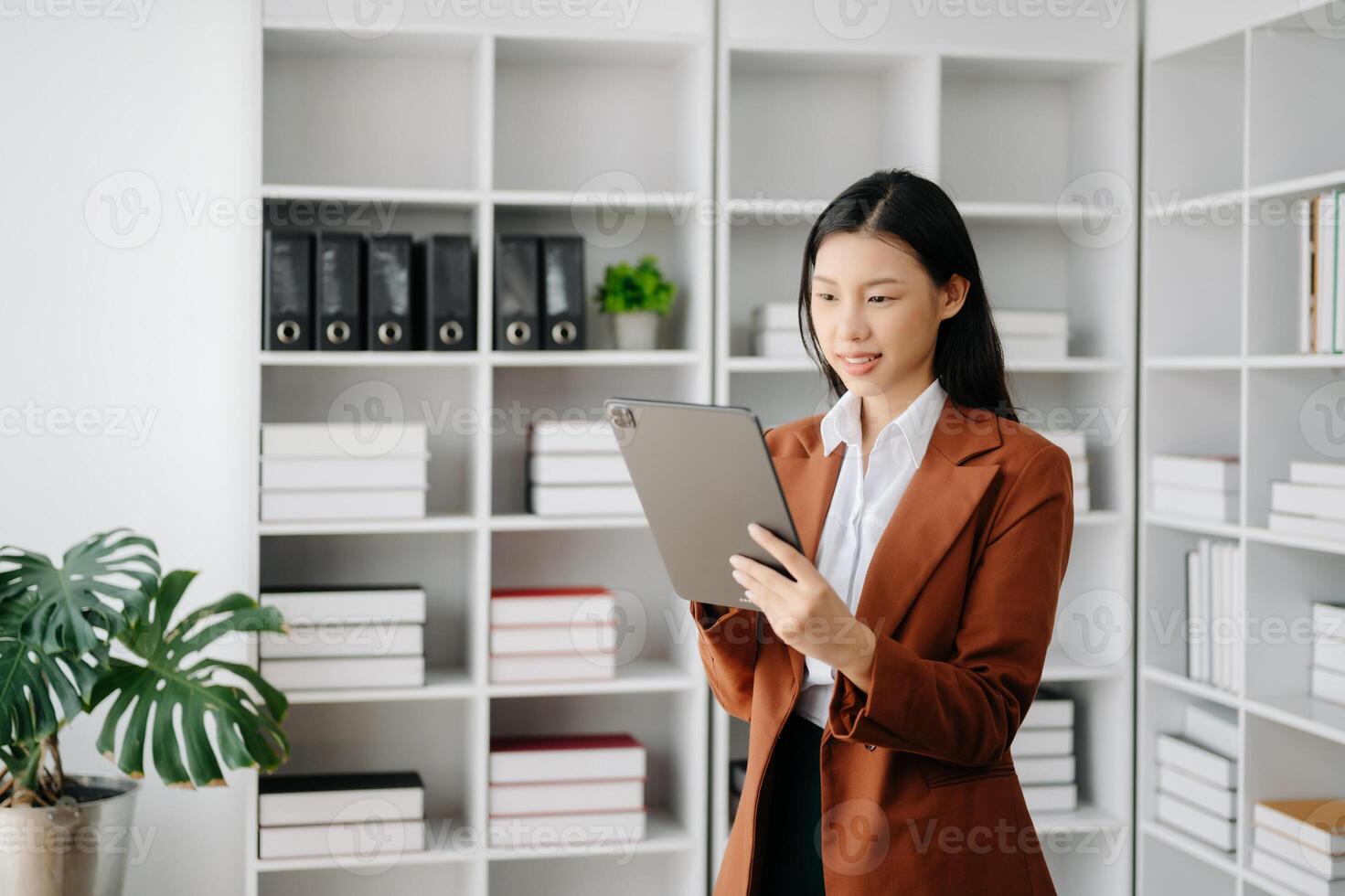 Business woman using tablet and laptop for doing math finance on an office desk, tax, report, accounting, statistics, and analytical research concept in office photo