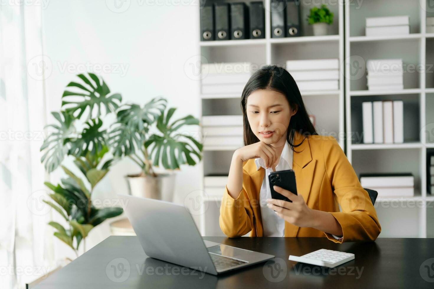 Business woman using tablet and laptop for doing math finance on an office desk, tax, report, accounting, statistics, and analytical research concept in office photo