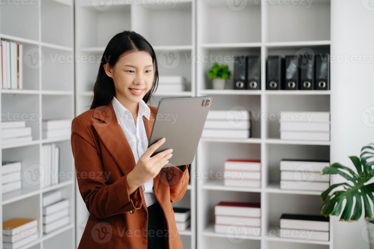 Business woman using tablet and laptop for doing math finance on an office desk, tax, report, accounting, statistics, and analytical research concept in office photo