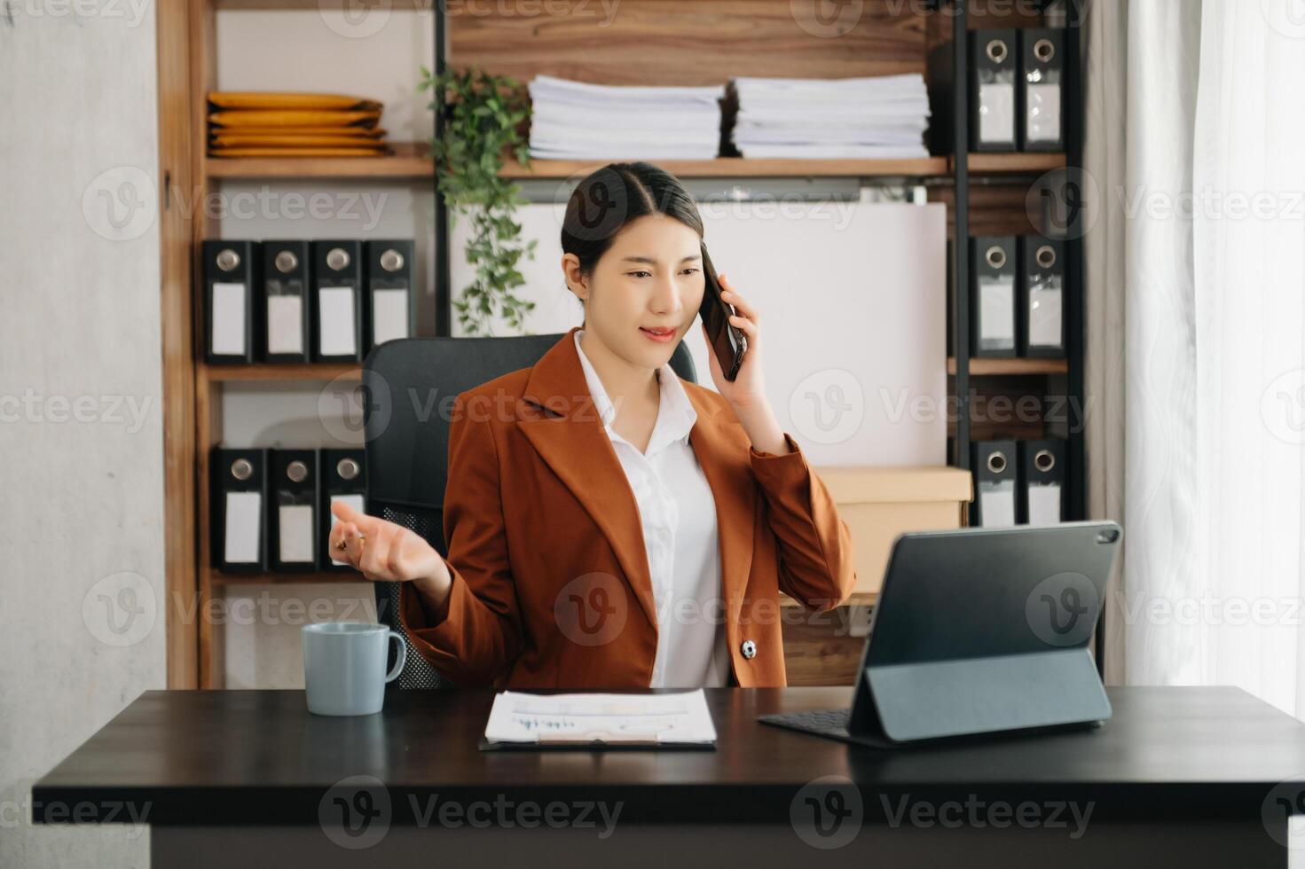 Business woman using tablet and laptop for doing math finance on an office desk, tax, report, accounting, statistics, and analytical research concept in office photo