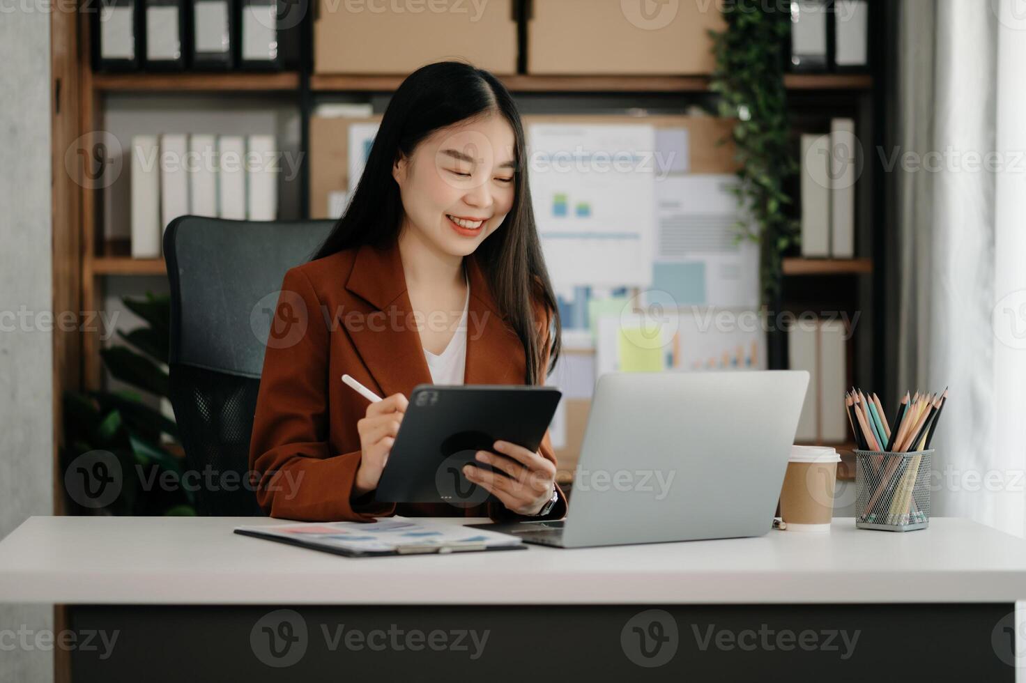Business woman using tablet and laptop for doing math finance on an office desk, tax, report, accounting, statistics, and analytical research concept photo
