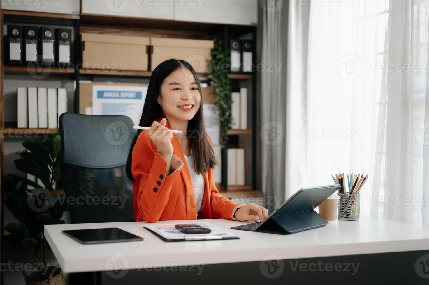 Business woman using tablet and laptop for doing math finance on an office desk, tax, report, accounting, statistics, and analytical research concept photo