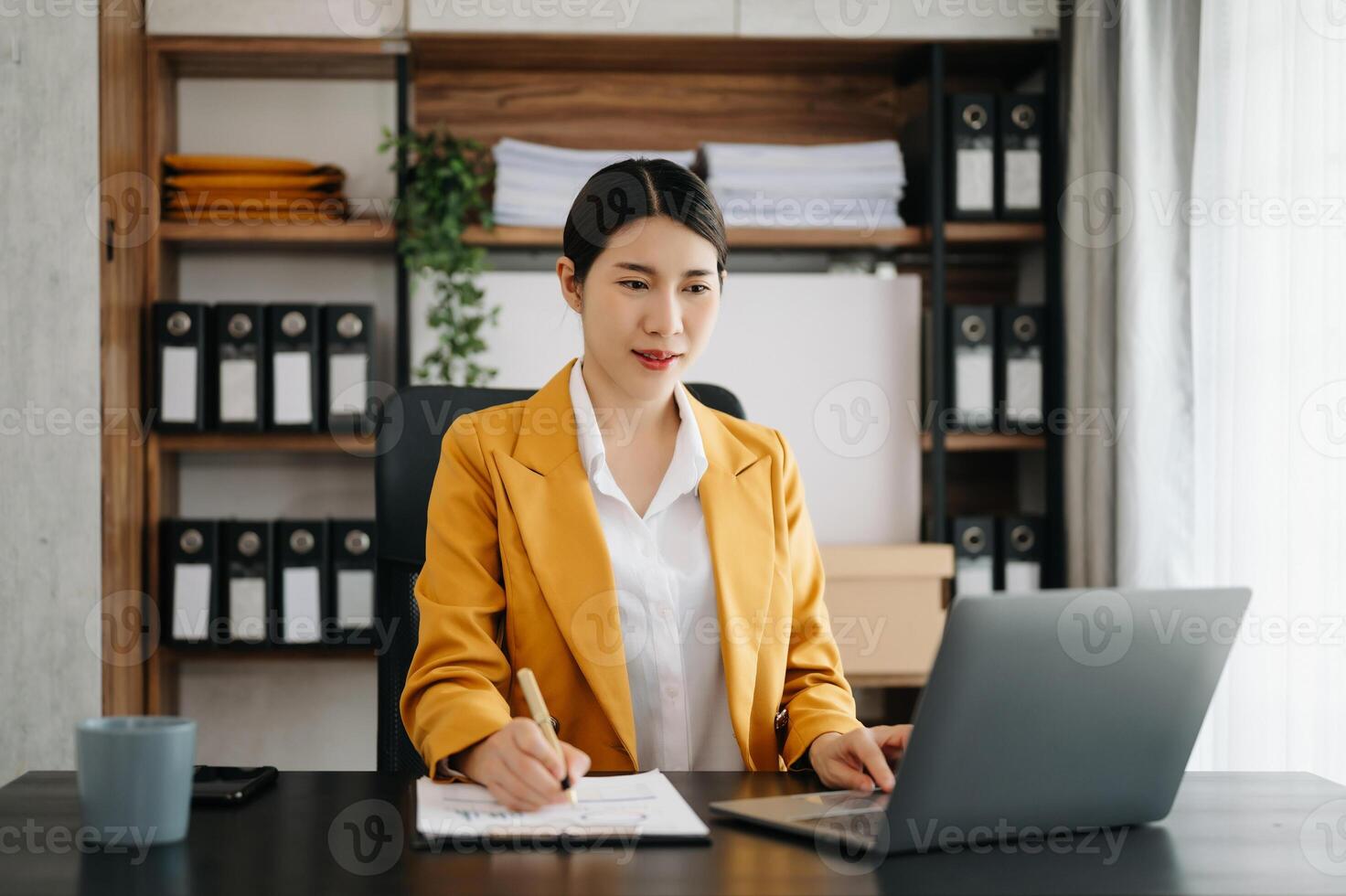 Business woman using tablet and laptop for doing math finance on an office desk, tax, report, accounting, statistics, and analytical research concept in office photo