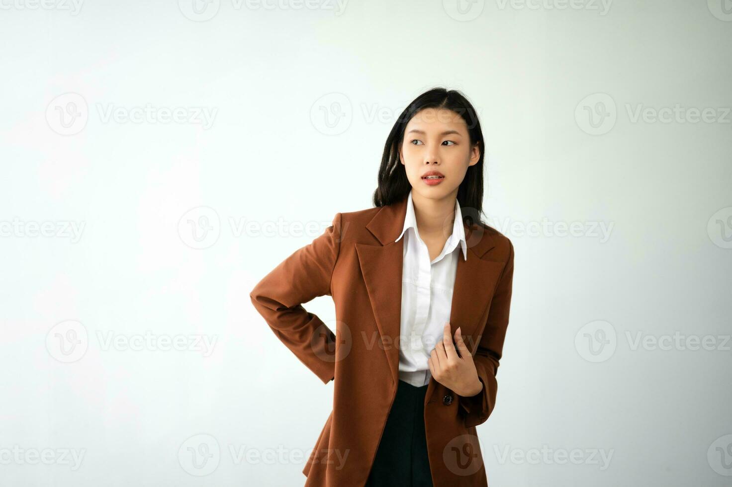 Portrait photo of young beautiful Asian woman feeling happy and holding smart phone, tablet and laptop with black empty screen on white background product presenting concept.