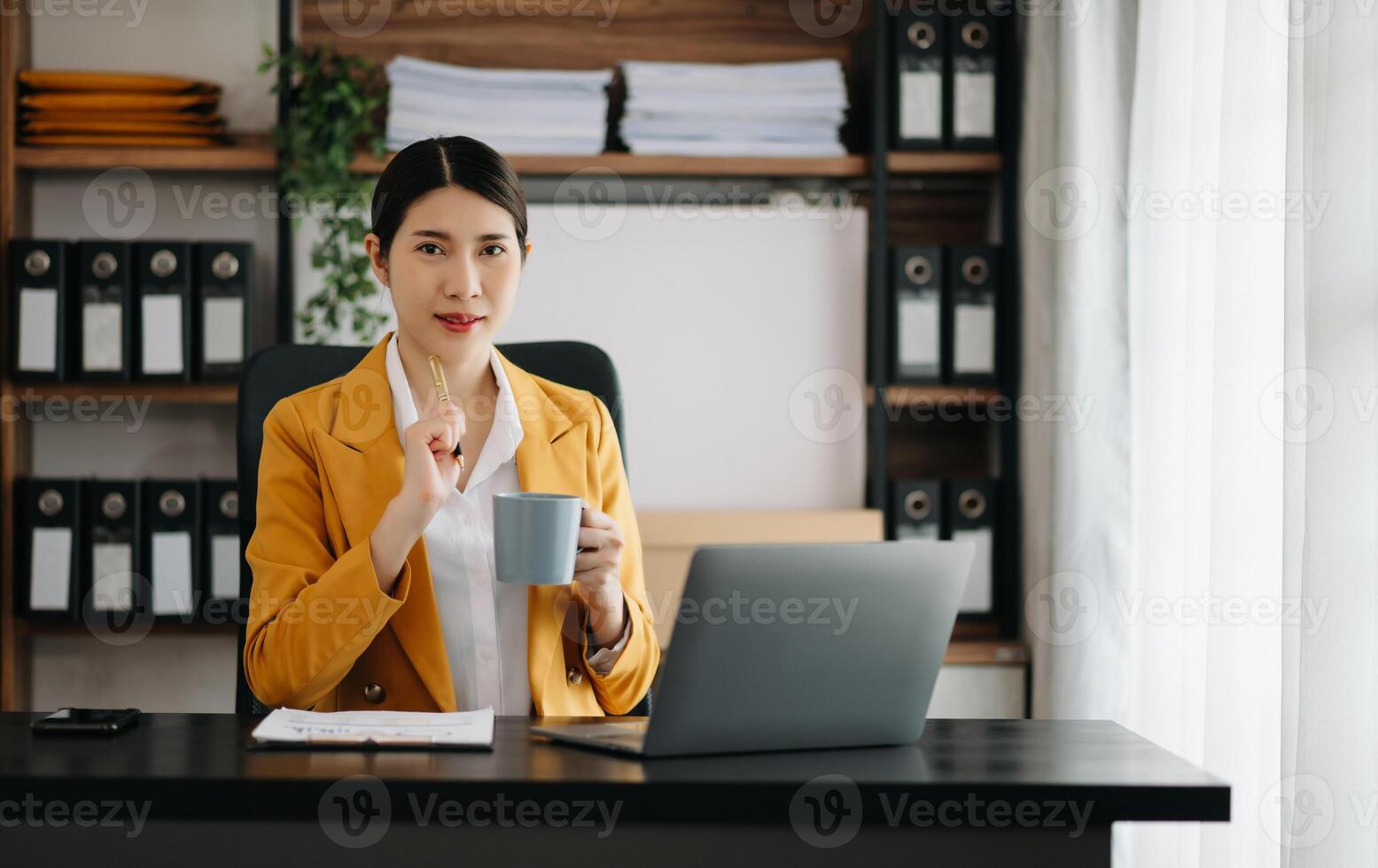 Business woman using tablet and laptop for doing math finance on an office desk, tax, report, accounting, statistics, and analytical research concept in office photo