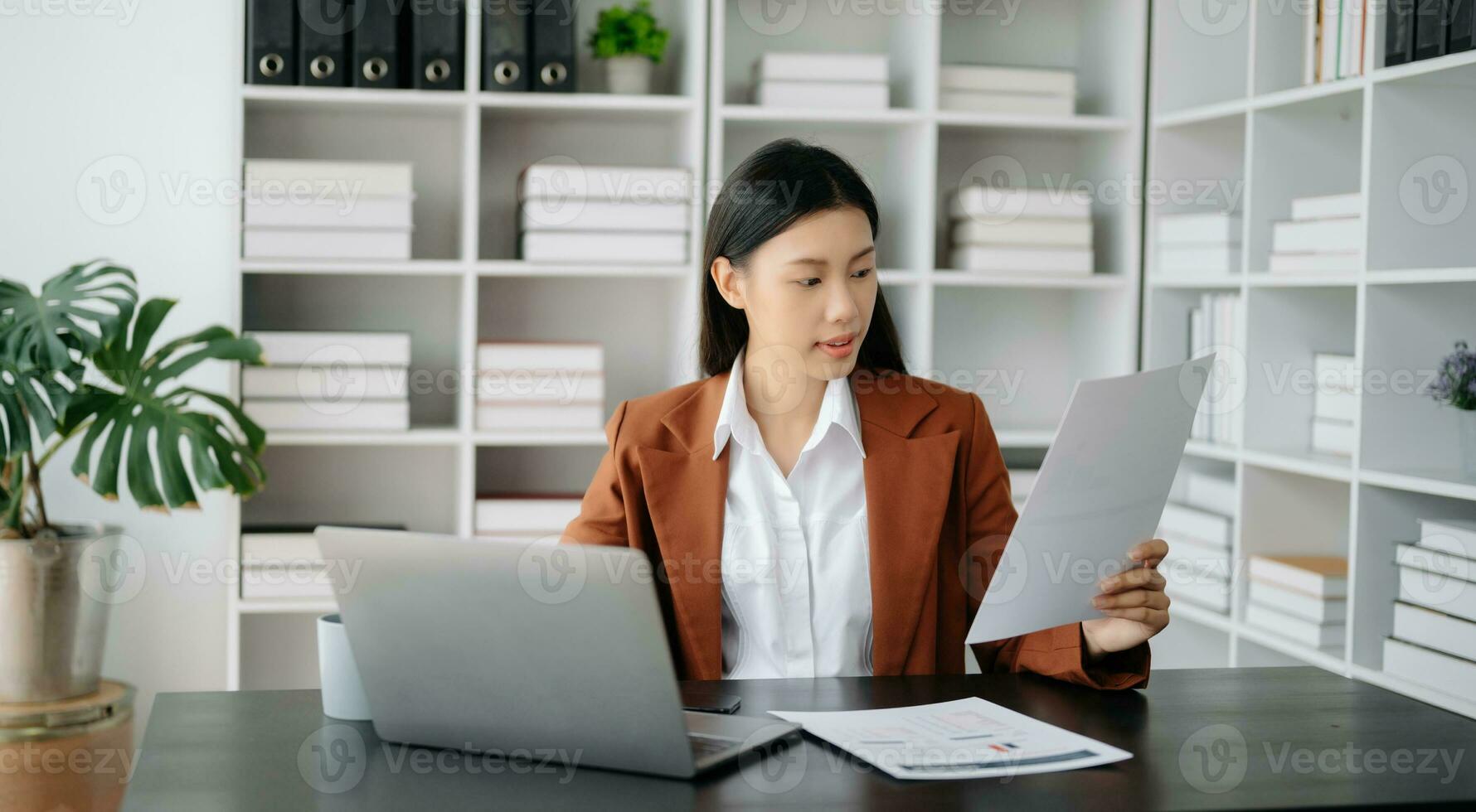 Business woman using tablet and laptop for doing math finance on an office desk, tax, report, accounting, statistics, and analytical research concept in office photo
