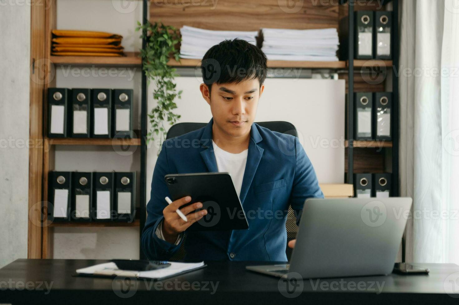 business man executive manager looking at laptop watching online webinar training or having virtual meeting video conference doing market research working in office. photo