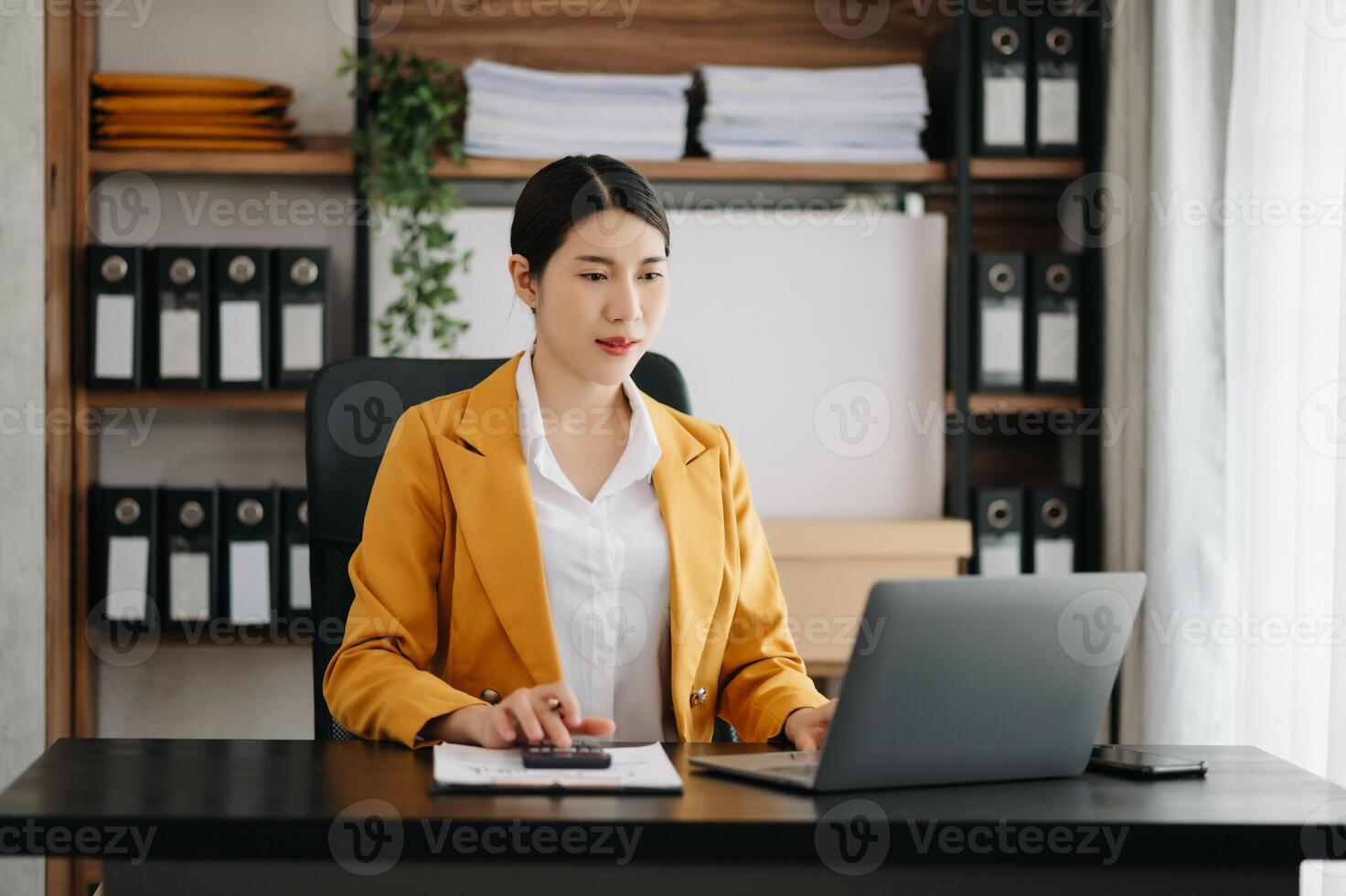 Business woman using tablet and laptop for doing math finance on an office desk, tax, report, accounting, statistics, and analytical research concept in office photo