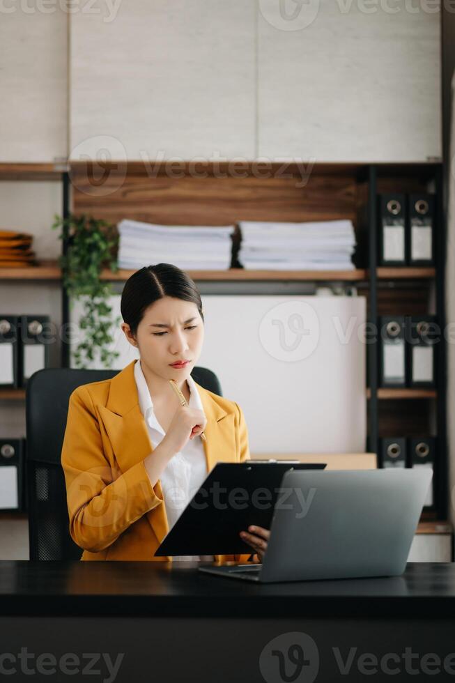 Business woman using tablet and laptop for doing math finance on an office desk, tax, report, accounting, statistics, and analytical research concept in office photo