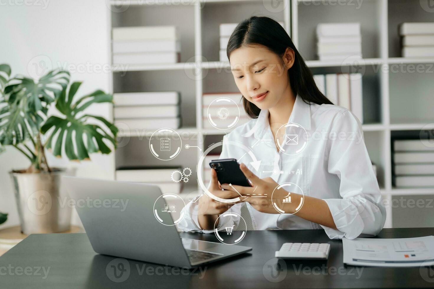 Businesswoman hand working digital marketing media in virtual screen with mobile phone and modern compute with VR icon diagram at office photo