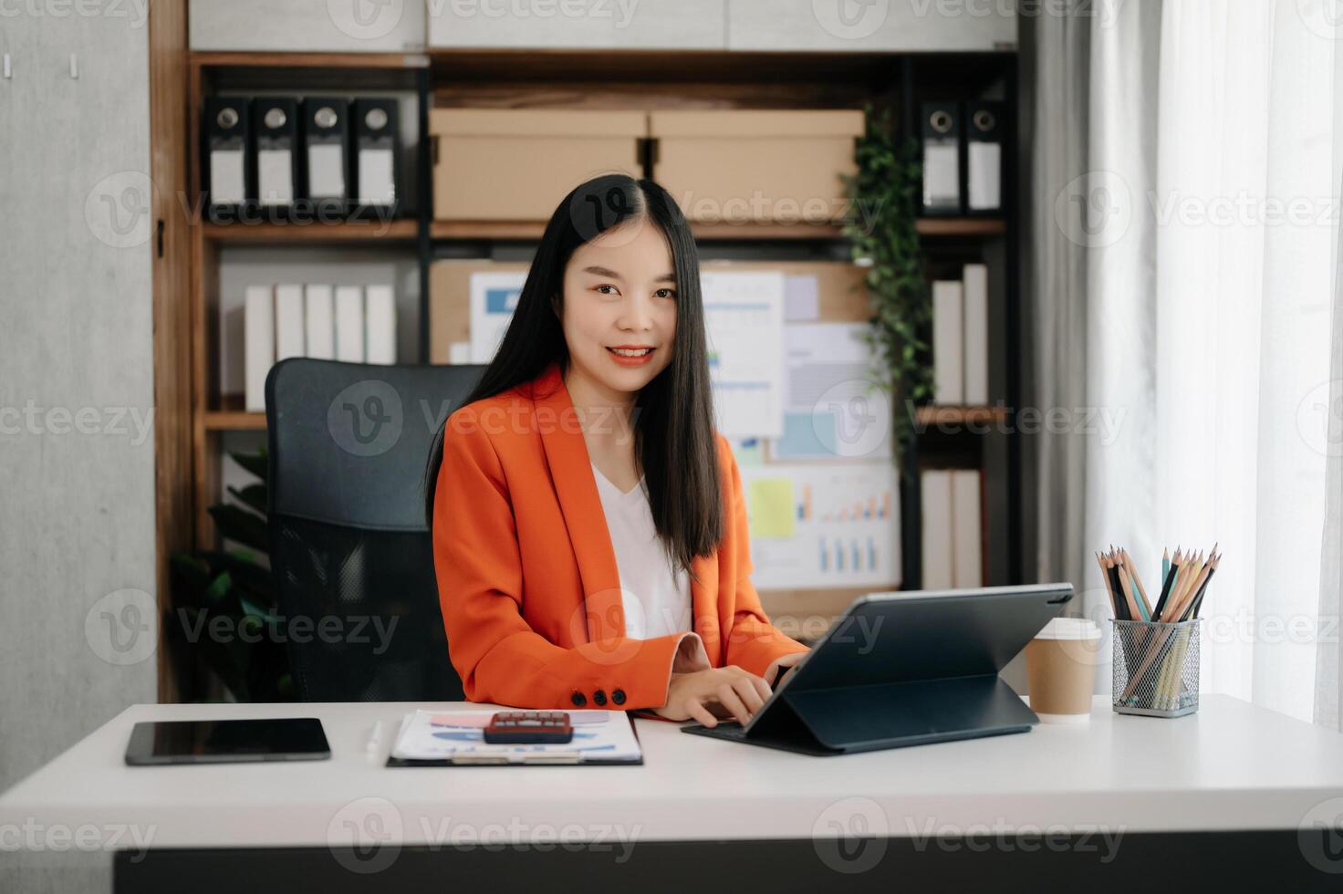 Business woman using tablet and laptop for doing math finance on an office desk, tax, report, accounting, statistics, and analytical research concept photo