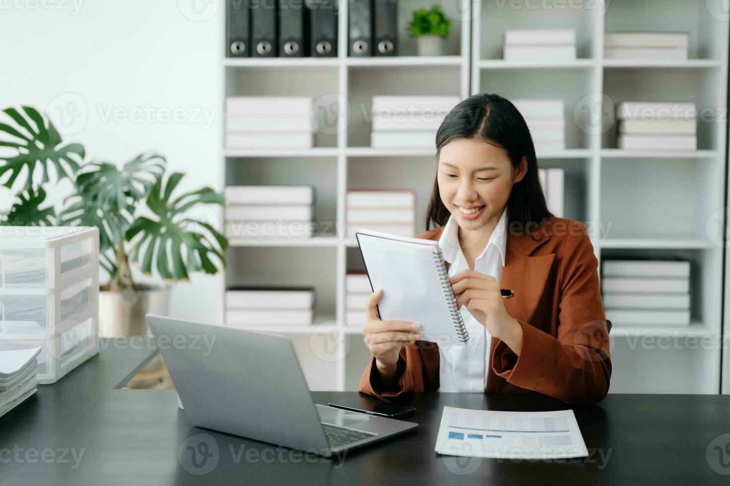 Business woman using tablet and laptop for doing math finance on an office desk, tax, report, accounting, statistics, and analytical research concept in office photo