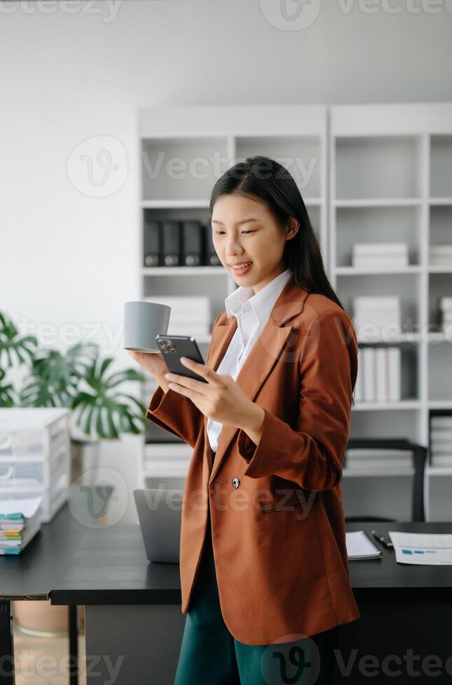 Business woman using tablet and laptop for doing math finance on an office desk, tax, report, accounting, statistics, and analytical research concept in office photo