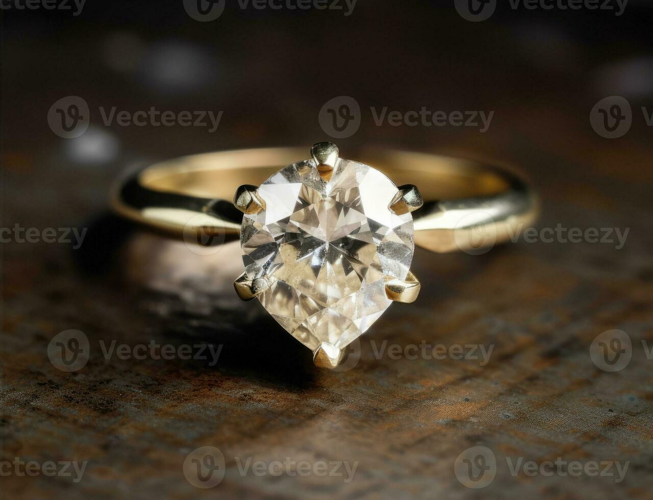 Gold ring with diamond in the shape of drop with reflection photo