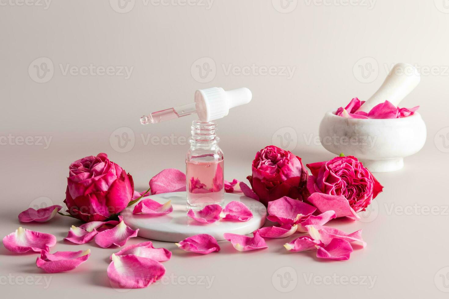 Moisturizing oil fluid in an open cosmetic bottle with a pipette for the face with an extract of rose petals for facial skin care. natural care . photo