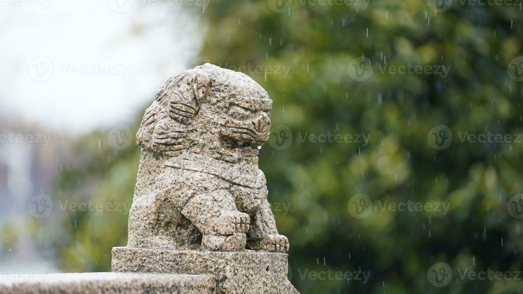 The old stone lion sculpture view along the old arched stone bridge in the old little town of the China photo